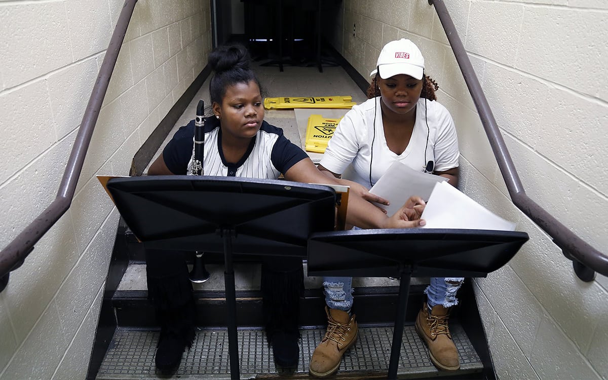 In December 2017, Sto-Rox Junior-Senior High School students Alayha Lee Rice (left) and Asia Johnson practice playing clarinet in a hallway during band class.