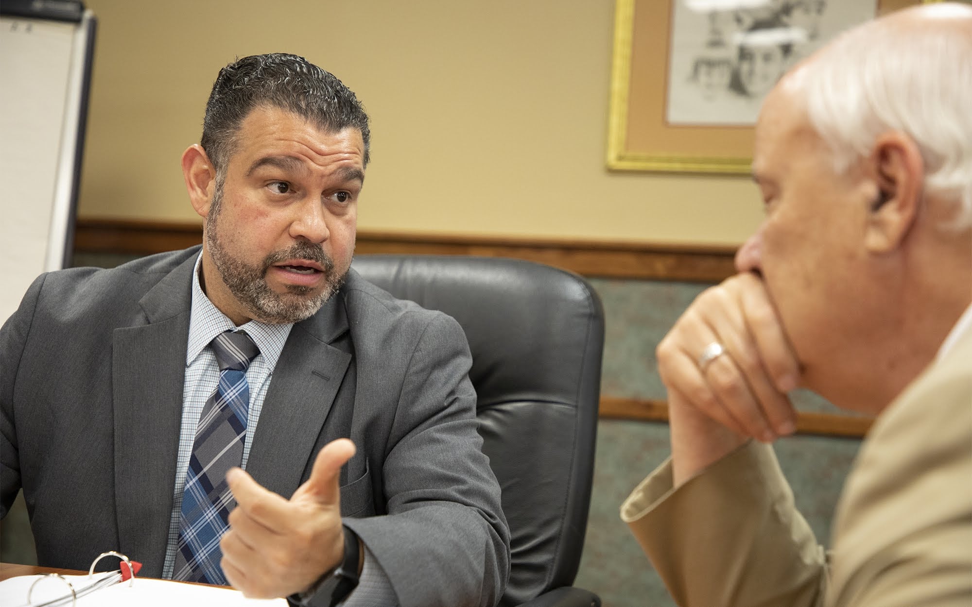 Pennsylvania Secretary of Education Pedro A. Rivera speaks with the executive director of Intermediate Unit I, Charles F. Mahoney III, at its headquarters in Coal Center, Pa., on June 12, 2018.