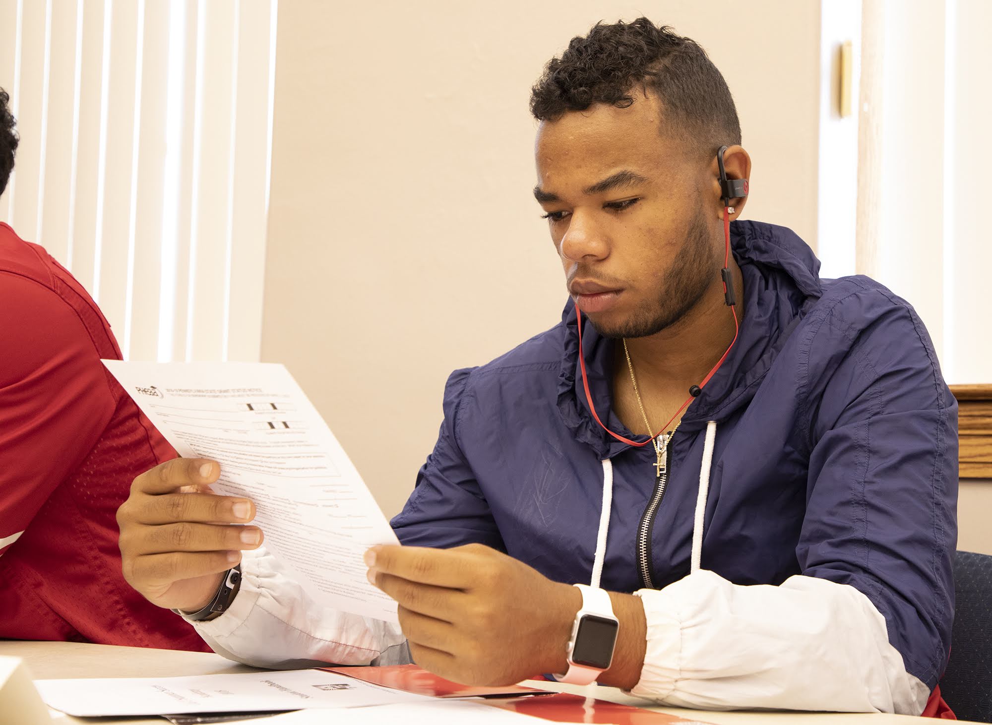 Brycen Simpson, 20, of New Kensington, looks over paperwork from the Pennsylvania Higher Education Assistance Agency during the Summer Success Academy at California University of Pennsylvania on Aug. 14, 2018.