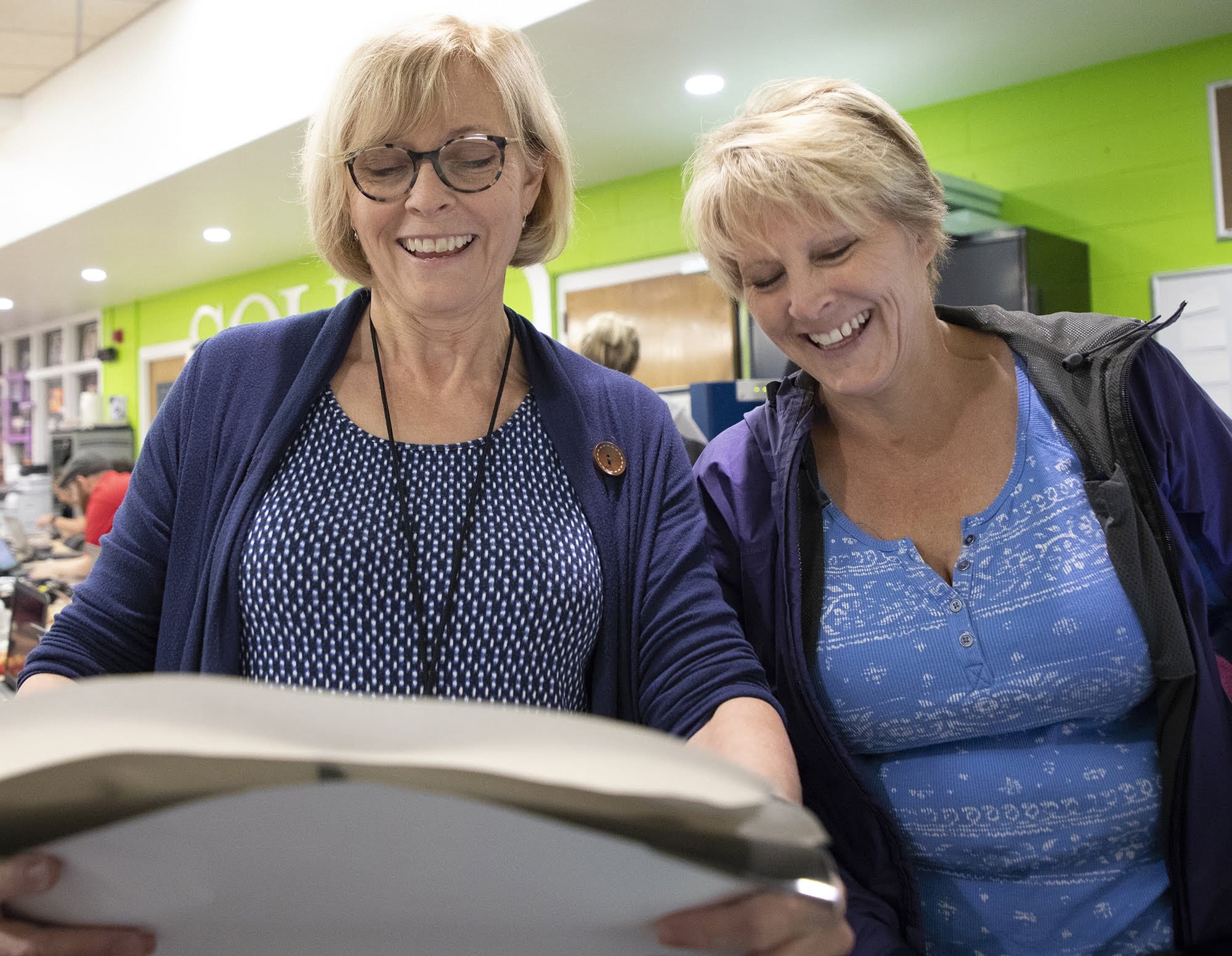 Sally Kunkel, a teacher at the Clairton School District, laughs with her sister, Wendy Pasternack, also a teacher at the Elizabeth Forward School District, after feeding paper into the vinyl cutter at the FAB Institute at Elizabeth Forward High School on June 21.