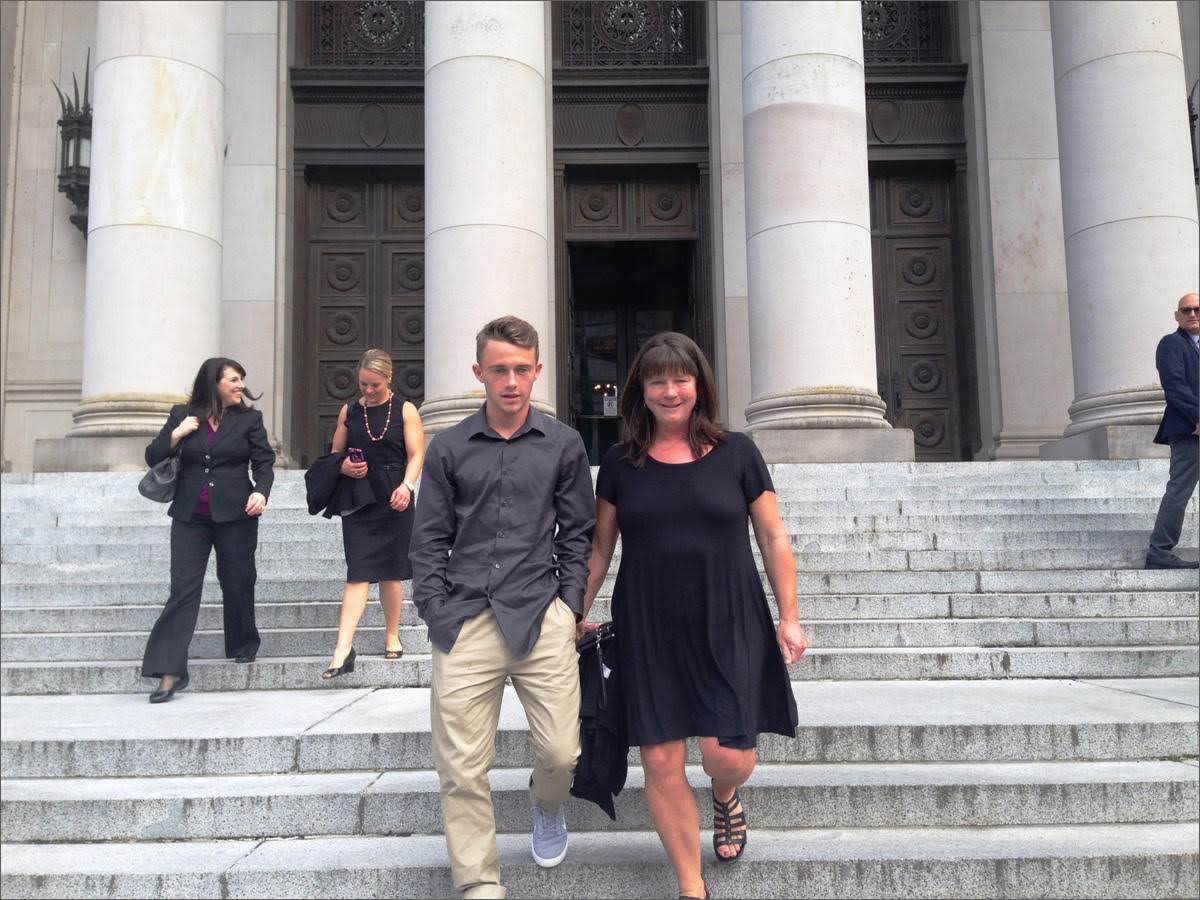 In this 2016 photo, Stephanie McCleary and her son, Carter, leave the Washington Supreme Court following a hearing in the nearly decade-old school funding lawsuit that bears their name. (Photo by Austin Jenkins/Northwest News Network)